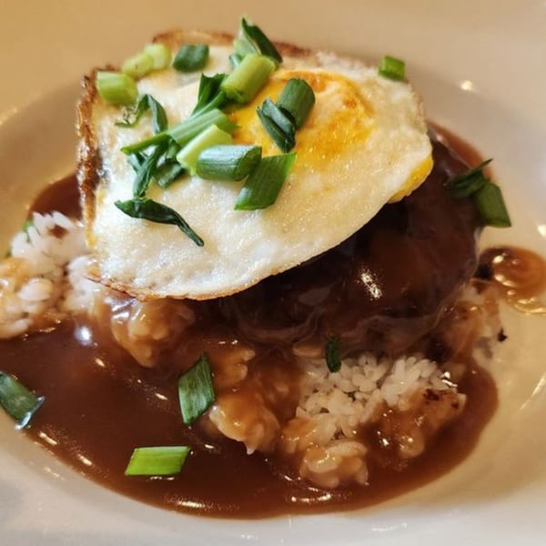Wild Duck Cafe's Loco Moco with a fried egg, gravy, and green onions over rice.